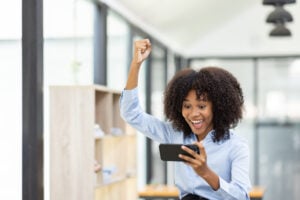 Advanta – Stock Photo – Celebrating While Using a Smartphone at Home – 8160×5443 – Active Perks_photo1